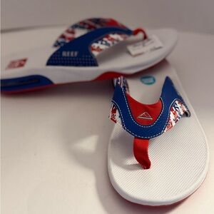 Reef Fanning Bottle Opener Flip Flops with Red/White/Blue Pattern Men’s 10